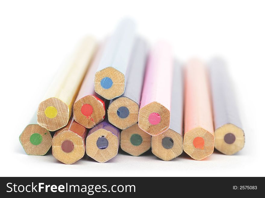 Colored wooden Crayons. Isolated on white background. Soft focus.