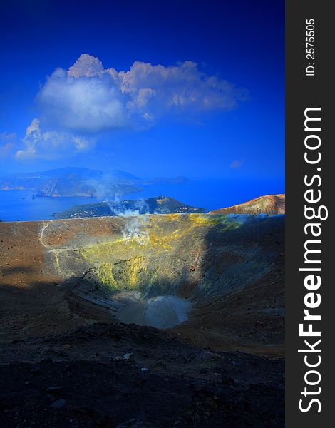 Alone on the top of the volcano. Vulcano island in Italy. Superb sight over the sea and the small islands. Alone on the top of the volcano. Vulcano island in Italy. Superb sight over the sea and the small islands.