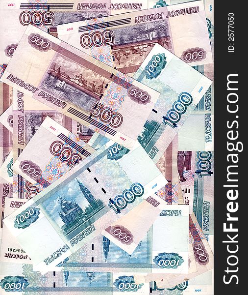 Some denominations of denomination in five hundred and one thousand roubles Russia laying in the any order, forming a background. Some denominations of denomination in five hundred and one thousand roubles Russia laying in the any order, forming a background