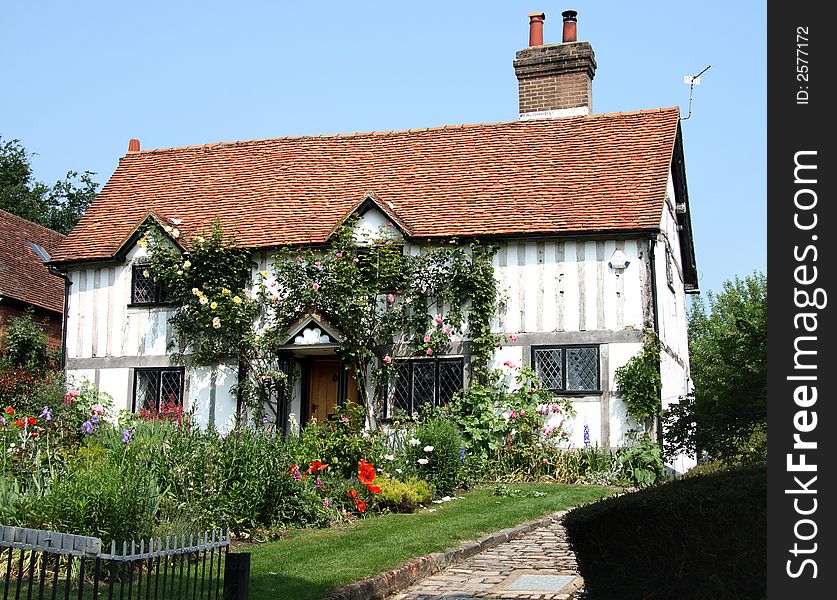 Flower covered Timber Framed Cottage and Garden in a Rural England. Flower covered Timber Framed Cottage and Garden in a Rural England