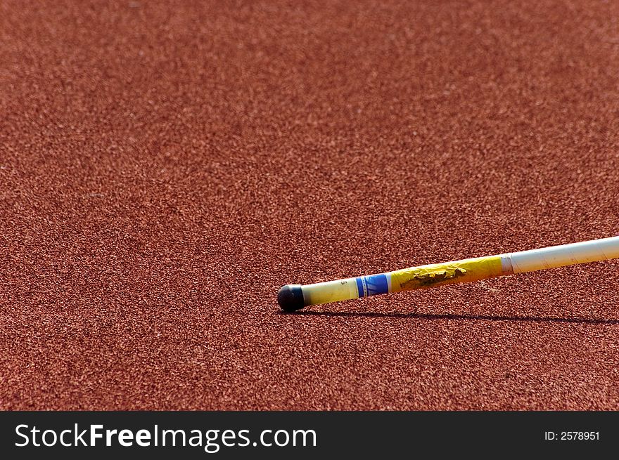 Pole jumping pole lying on a track