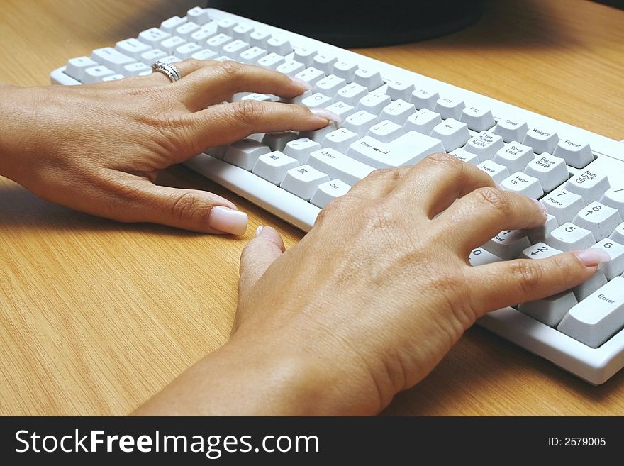 Closeup of woman typing on a keyboard