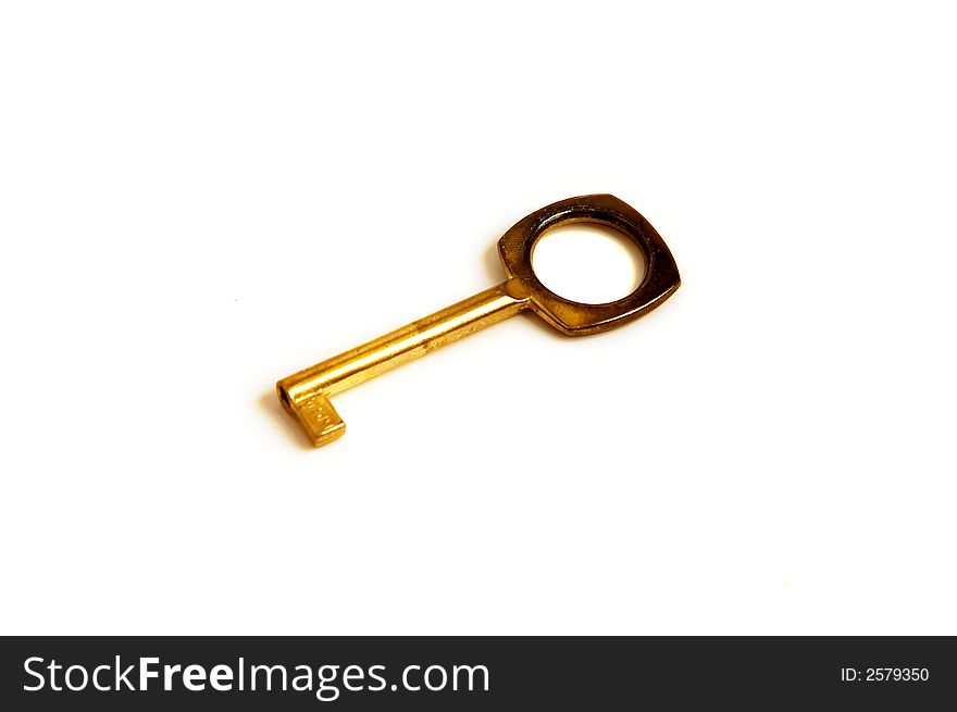 A simple isolated golden key. A simple isolated golden key