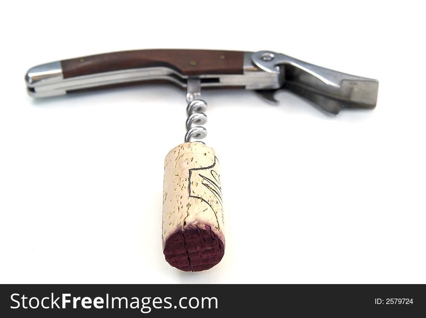 Corkscrew with wooden handle, red wine soaked cork attached. Corkscrew with wooden handle, red wine soaked cork attached