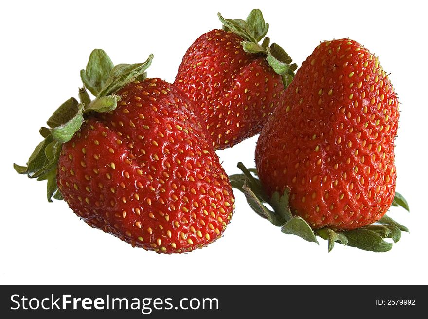 Close-up of three strawberries on white