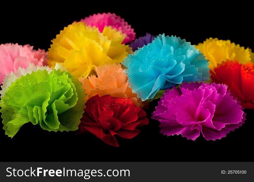 Colorful handcrafted flower on black background