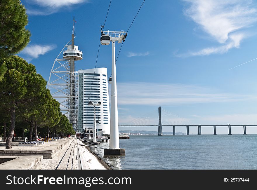 Quay of Tegos river with Vasco da Gama tower and bridge on background, Lisbon