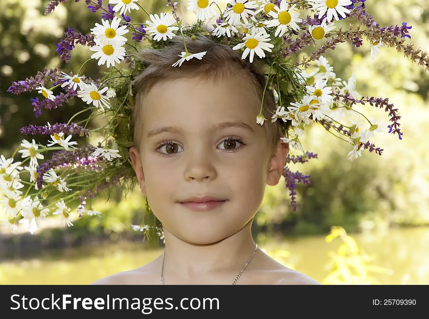 Happy boy with a wreath on his head.