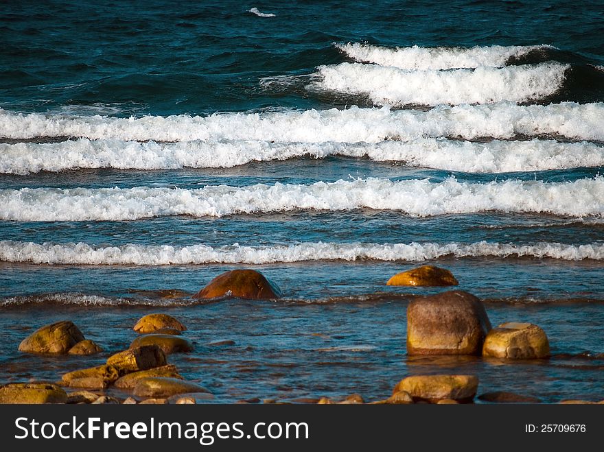 Waves rolling in to a rocky beach