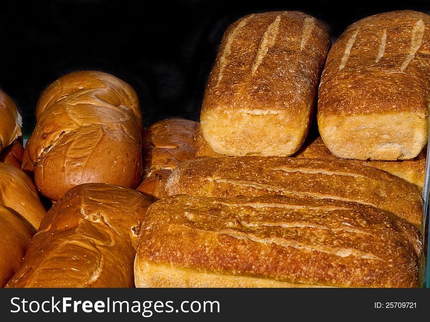 Different kinds of bread loafs stacked. Different kinds of bread loafs stacked