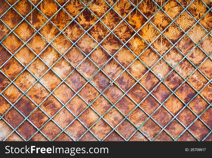 Old rusty fence with a lattice and steel sheet substrate background. Old rusty fence with a lattice and steel sheet substrate background