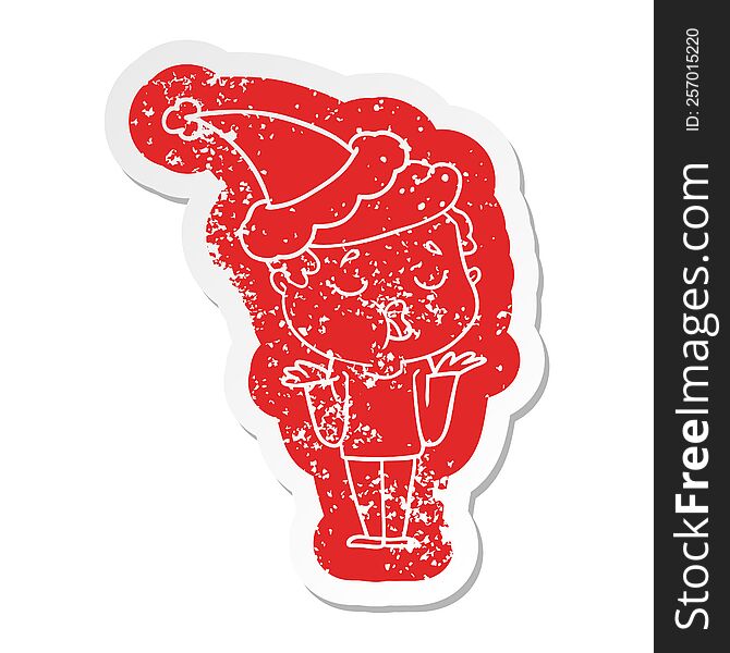 cartoon distressed sticker of a man talking and shrugging shoulders wearing santa hat