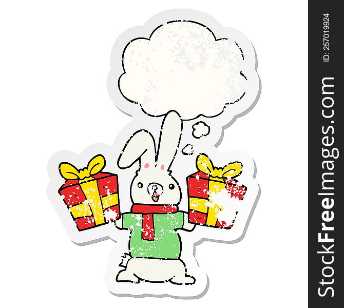 Cartoon Rabbit With Christmas Presents And Thought Bubble As A Distressed Worn Sticker