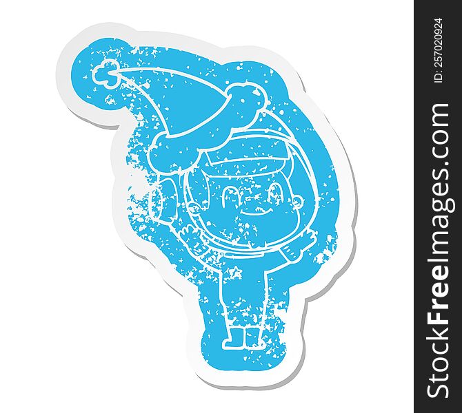 Happy Cartoon Distressed Sticker Of A Astronaut Man Wearing Santa Hat