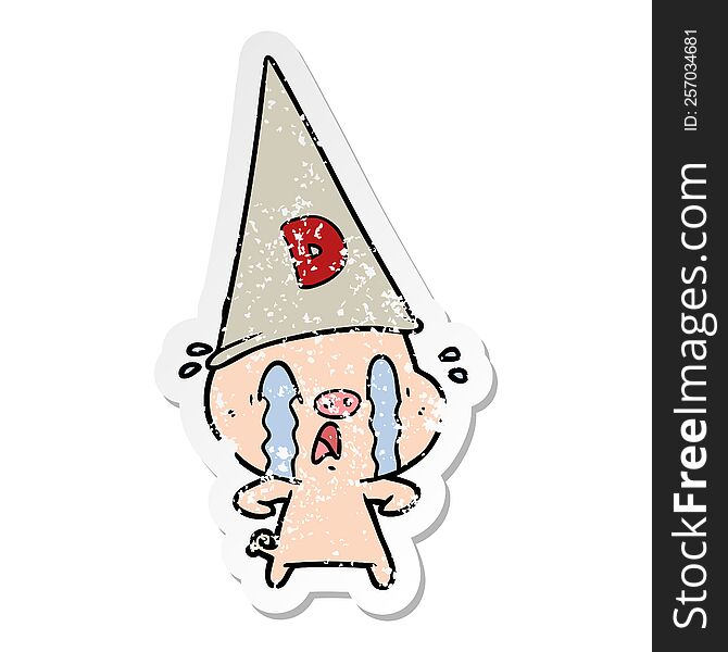 distressed sticker of a crying pig wearing dunce hat