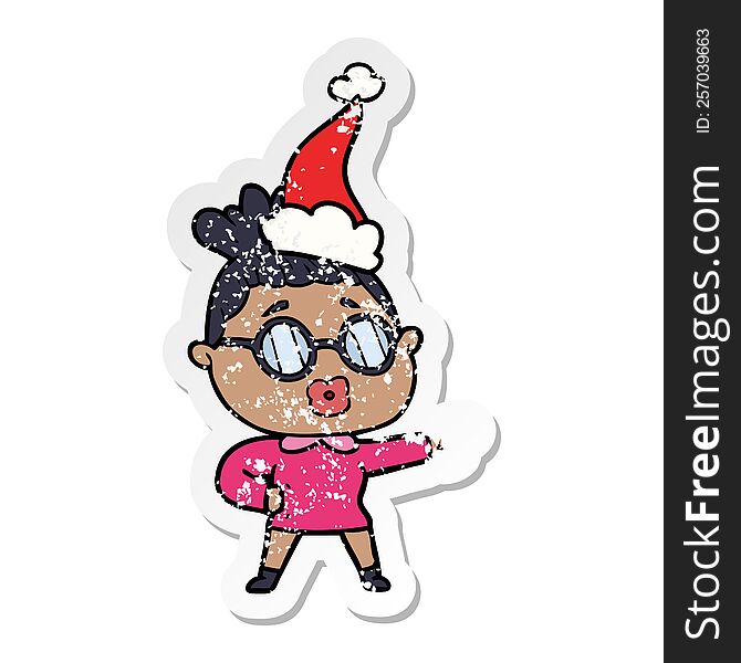 distressed sticker cartoon of a pointing woman wearing spectacles wearing santa hat