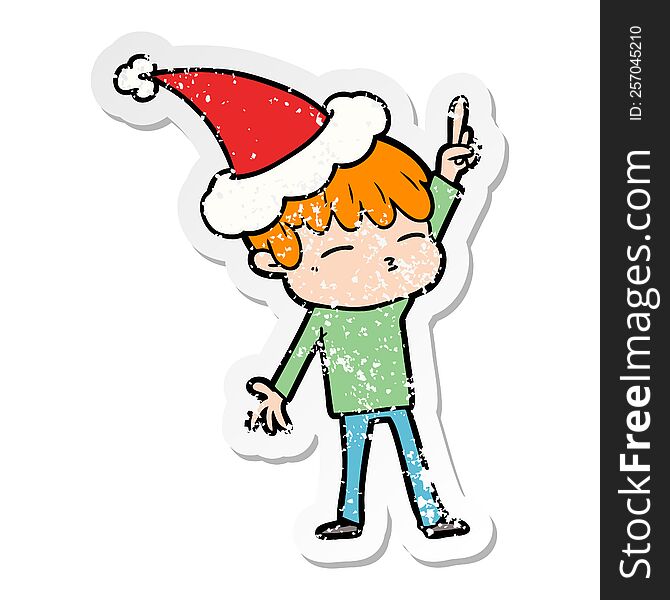 hand drawn distressed sticker cartoon of a curious boy wearing santa hat