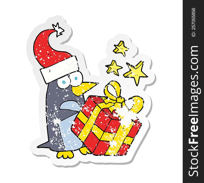 Retro Distressed Sticker Of A Cartoon Christmas Penguin With Present