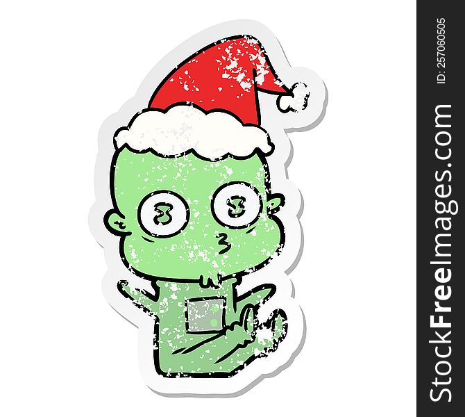 Distressed Sticker Cartoon Of A Weird Bald Spaceman Wearing Santa Hat