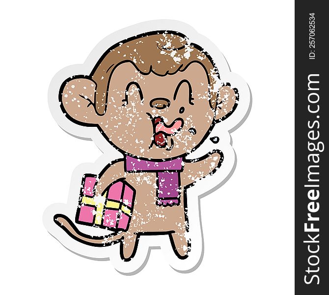 Distressed Sticker Of A Crazy Cartoon Monkey With Christmas Present