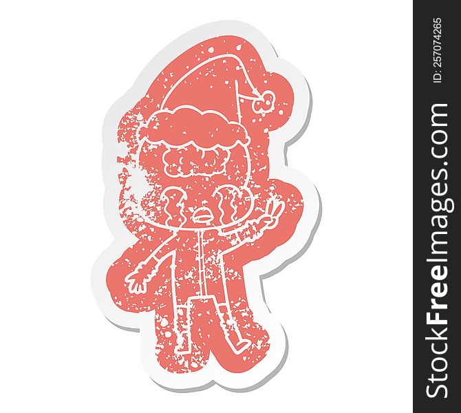 Cartoon Distressed Sticker Of A Big Brain Alien Crying And Giving Peace Sign Wearing Santa Hat