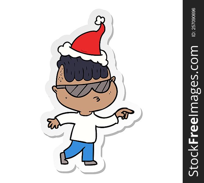 hand drawn sticker cartoon of a boy wearing sunglasses pointing wearing santa hat