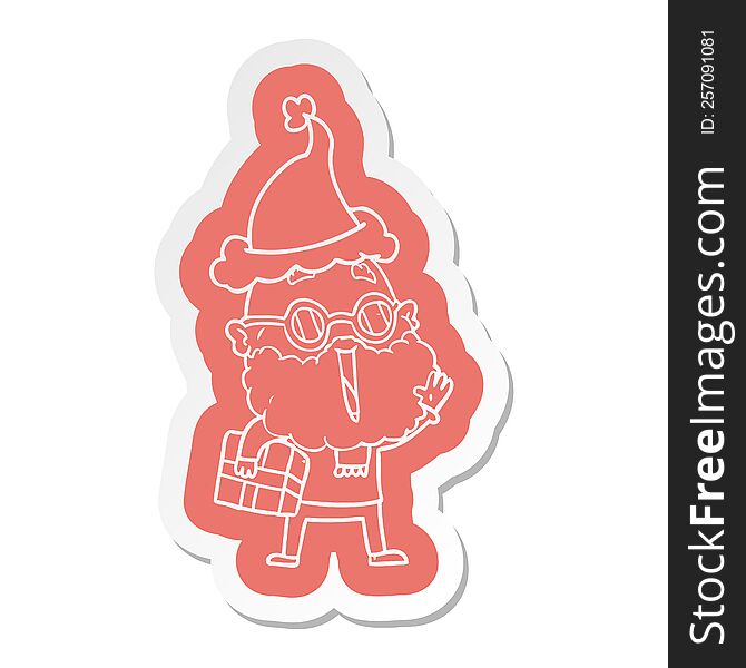 quirky cartoon  sticker of a joyful man with beard and parcel under arm wearing santa hat