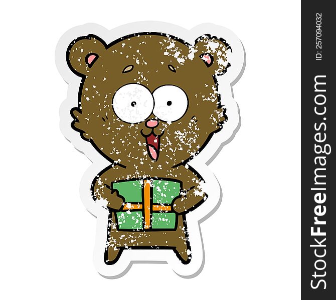 distressed sticker of a laughing teddy  bear with christmas present
