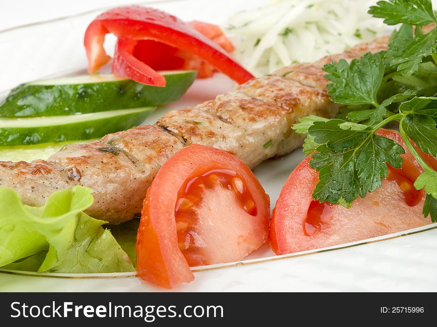 Grilled meat with fresh vegetables and herbs