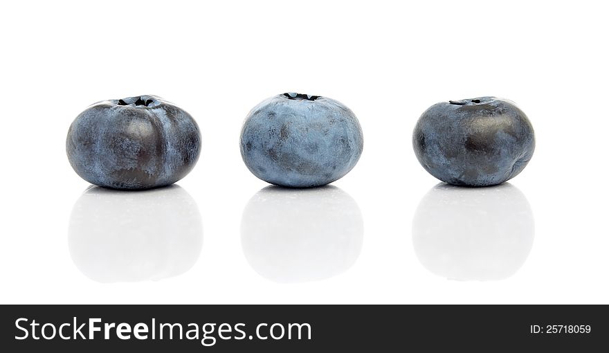 Three blueberries with reflection isolated on white background. Three blueberries with reflection isolated on white background