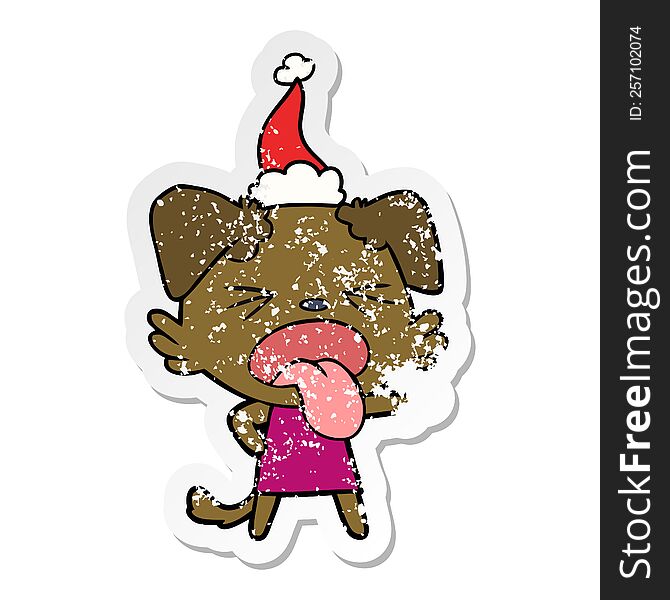 Distressed Sticker Cartoon Of A Disgusted Dog Wearing Santa Hat