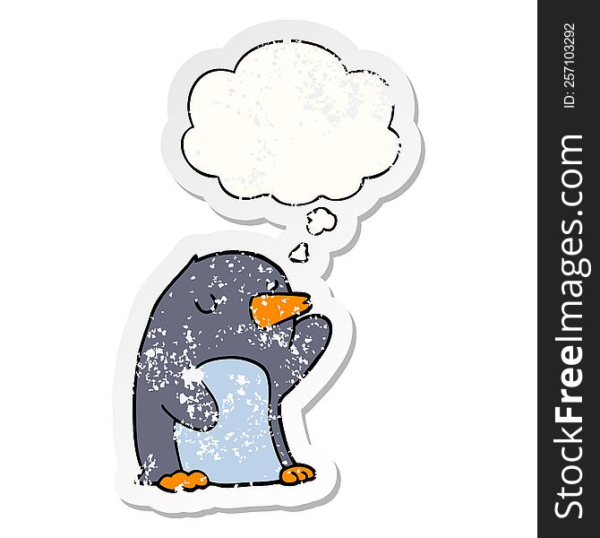 cartoon penguin with thought bubble as a distressed worn sticker