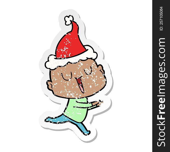 Happy Distressed Sticker Cartoon Of A Bald Man Wearing Santa Hat