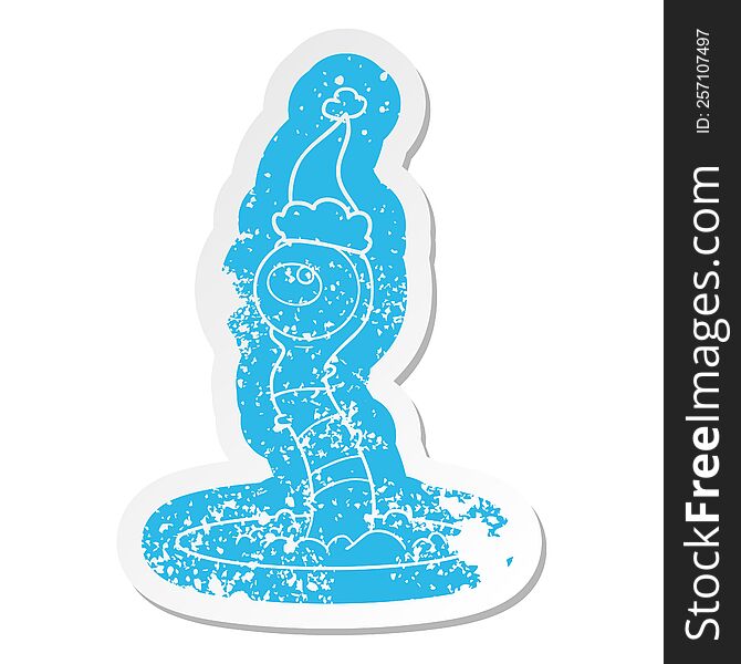 quirky cartoon distressed sticker of a alien swamp monster wearing santa hat