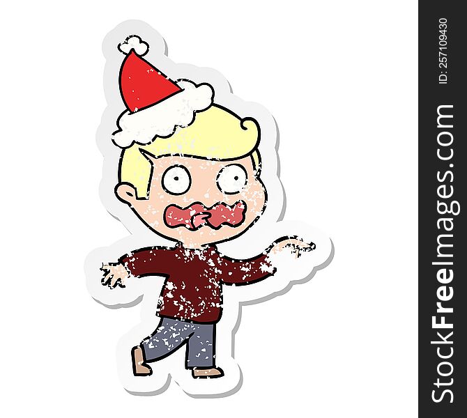 distressed sticker cartoon of a stressed out pointing wearing santa hat