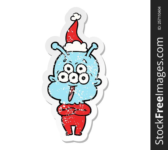 Happy Distressed Sticker Cartoon Of A Alien Wearing Santa Hat