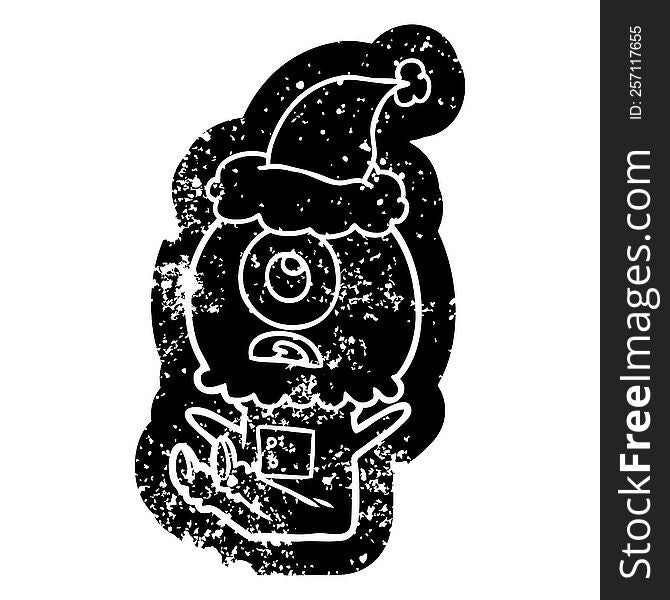 Cartoon Distressed Icon Of A Cyclops Alien Spaceman Wearing Santa Hat