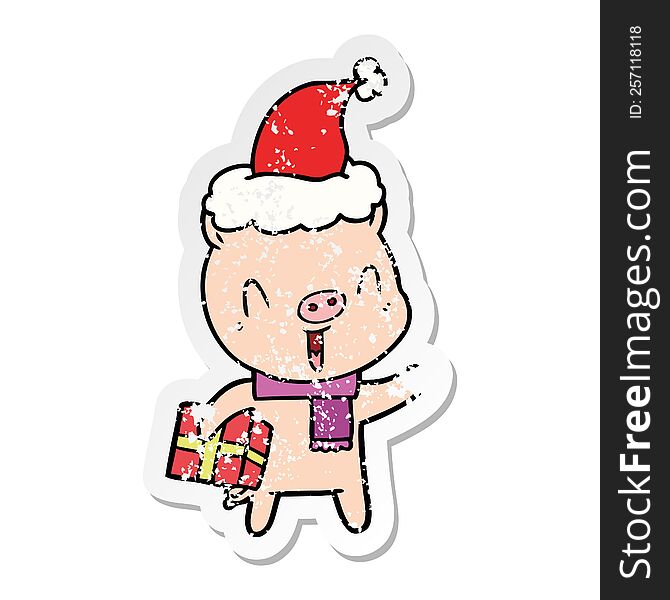 Happy Distressed Sticker Cartoon Of A Pig With Xmas Present Wearing Santa Hat