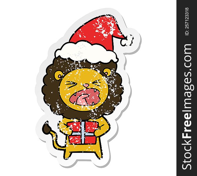 hand drawn distressed sticker cartoon of a lion with christmas present wearing santa hat