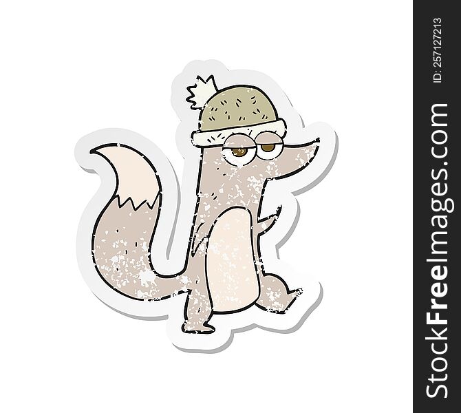 Retro Distressed Sticker Of A Cartoon Little Wolf Wearing Hat