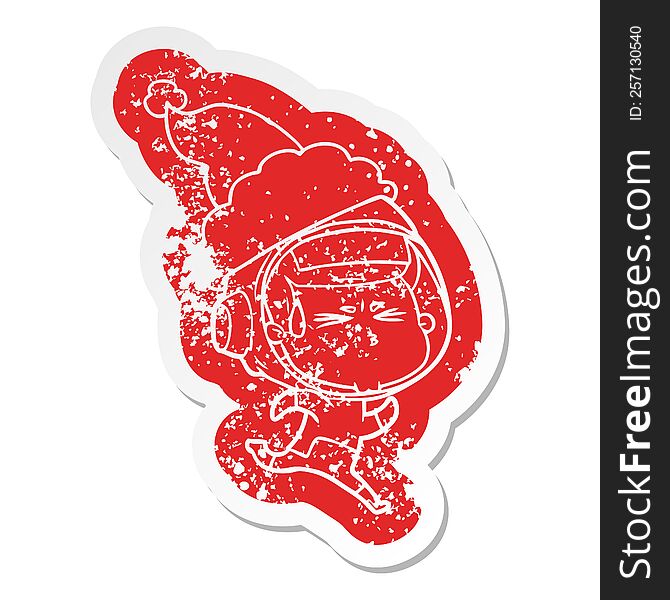quirky cartoon distressed sticker of a stressed astronaut wearing santa hat