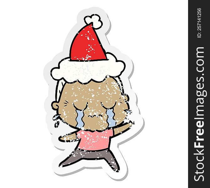 Distressed Sticker Cartoon Of A Crying Old Lady Wearing Santa Hat