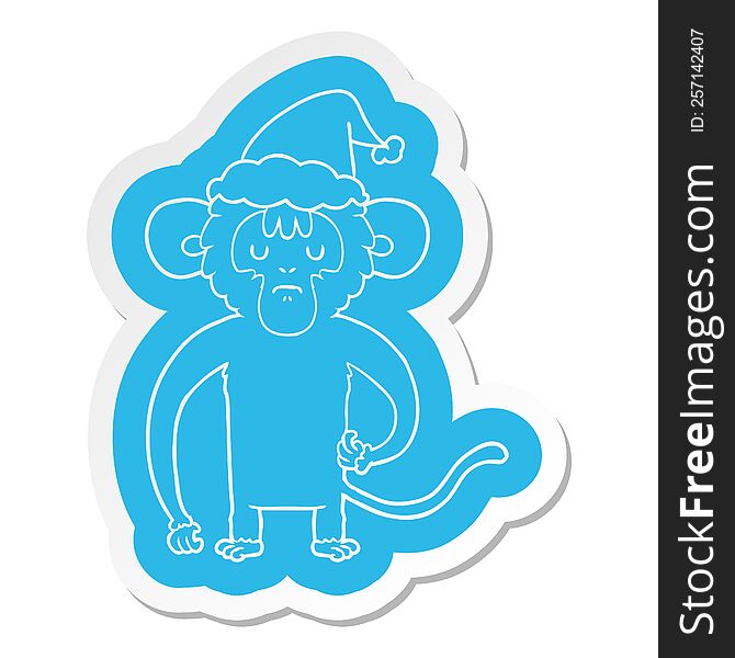 quirky cartoon  sticker of a monkey scratching wearing santa hat