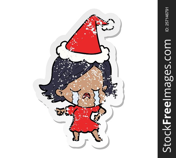 Distressed Sticker Cartoon Of A Girl Crying And Pointing Wearing Santa Hat