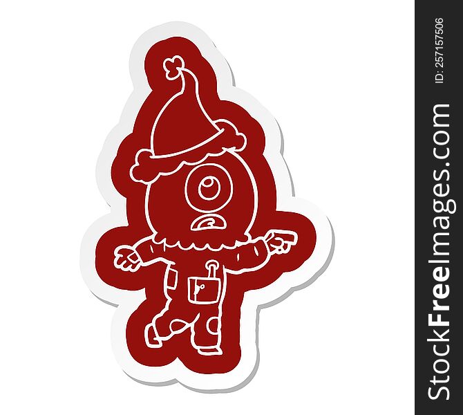 Cartoon  Sticker Of A Cyclops Alien Spaceman Pointing Wearing Santa Hat