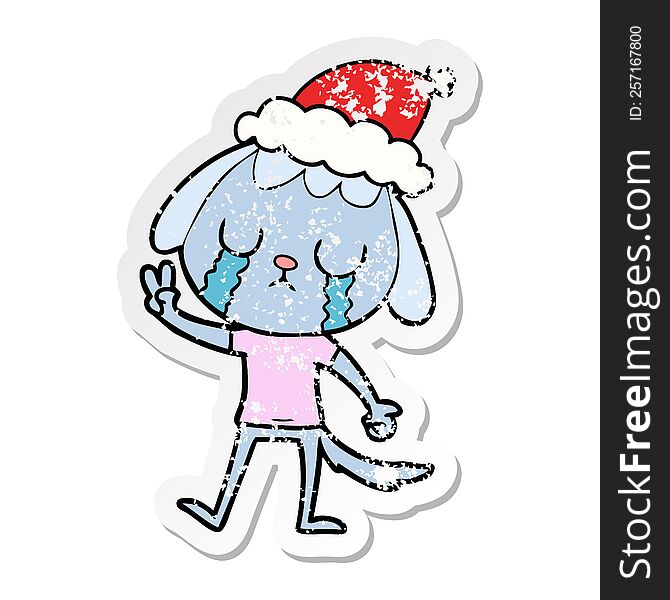 cute hand drawn distressed sticker cartoon of a dog crying wearing santa hat