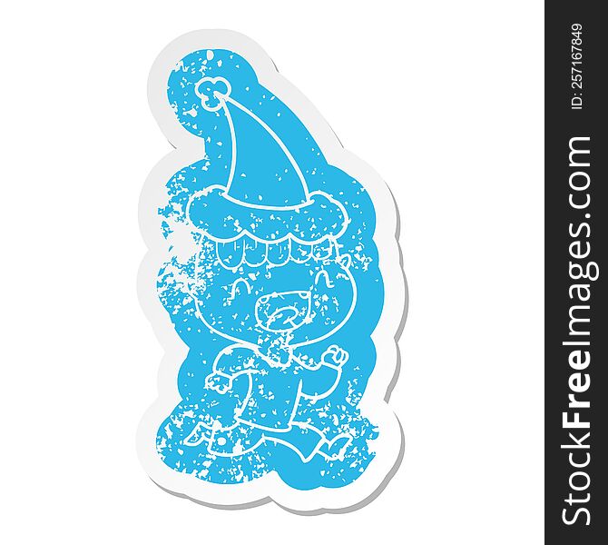 Cartoon Distressed Sticker Of A Happy Boy Laughing And Running Away Wearing Santa Hat