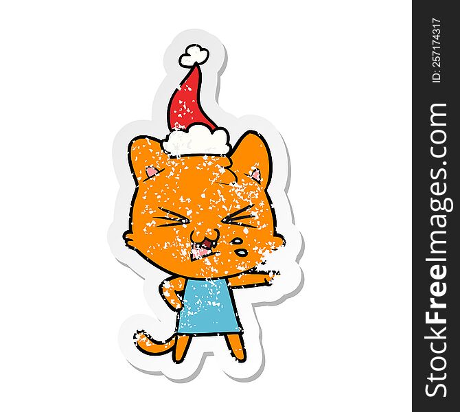 Distressed Sticker Cartoon Of A Hissing Cat Wearing Santa Hat