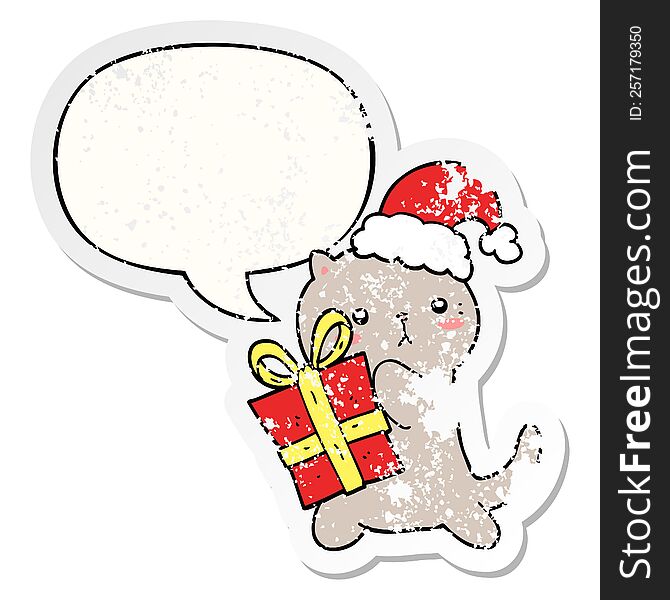 cute cartoon cat carrying christmas present with speech bubble distressed distressed old sticker. cute cartoon cat carrying christmas present with speech bubble distressed distressed old sticker