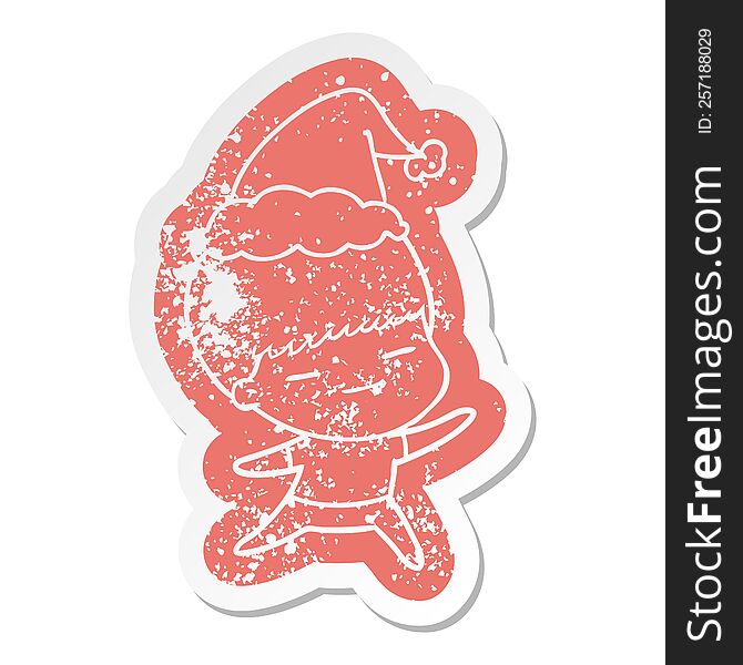 quirky cartoon distressed sticker of a smug boy wearing santa hat